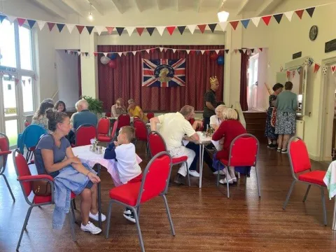 People sitting down having tea